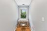 Windowed alcove featuring wood-finish flooring and light-toned walls
