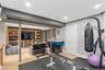 Recessed lighting illuminates the open-concept space with wood-finish flooring