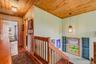 Stairway leading to 2nd level with pine ceilings