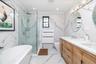 Bathroom with a freestanding tub and glass enclosed shower