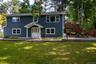 Front exterior of house and side deck and patio