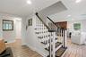 View of stairs to upper living level and Family Room in background