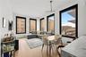 Dining area featuring light wood-type flooring, a chandelier, healthy amount of natural light, and a baseboard heating unit
