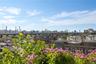 View of home's community with a skyline view and a patio area