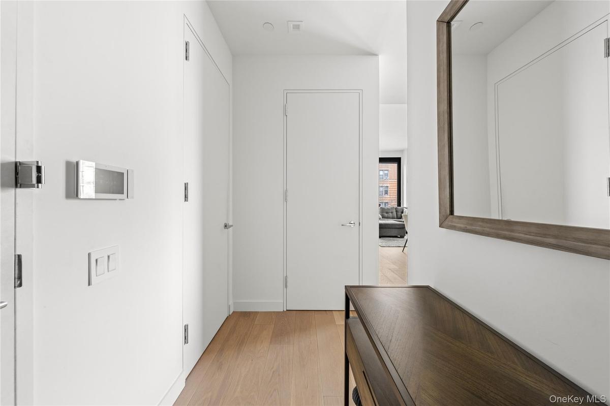 Hallway featuring light wood-style flooring