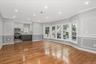 Unfurnished living room with crown molding, a decorative wall, light wood-style floors, and recessed lighting