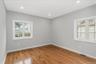 Empty room with light wood-style floors and recessed lighting