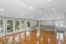 Unfurnished living room with crown molding, light wood-type flooring, a decorative wall, and recessed lighting