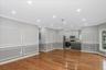 Unfurnished living room with a decorative wall, crown molding, light wood-style flooring, and recessed lighting