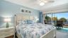 Large Primary Bedroom with a King Size bed, Walk in Closet, and sliders to the balcony.