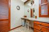 Built-in vanity with integrated storage cabinetry and a large wall-mounted mirror