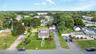 Two-story residence with dormer windows, a detached garage, and a long driveway