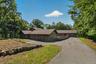 Second driveway approach to garage side entrances and additional parking.