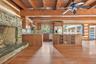 Kitchen and dining area with generous stone fireplace.
