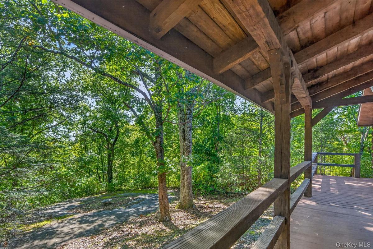 Front porch looking to circular driveway and natural surroundings.