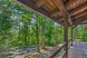 Front porch looking to circular driveway and natural surroundings.