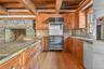 Cherry cabinetry with stainless steel appliances.