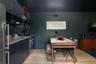 Kitchen featuring open shelves, stainless steel appliances, light wood-style floors, and under cabinet range hood