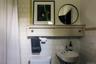Full bathroom with curtained shower and tile walls