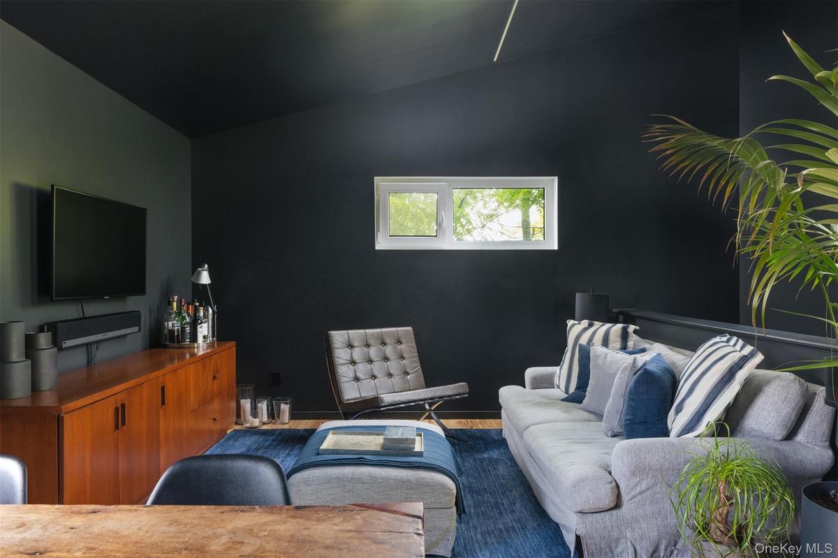 Living area with lofted ceiling and wood finished floors