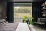 Bedroom featuring concrete flooring and multiple windows