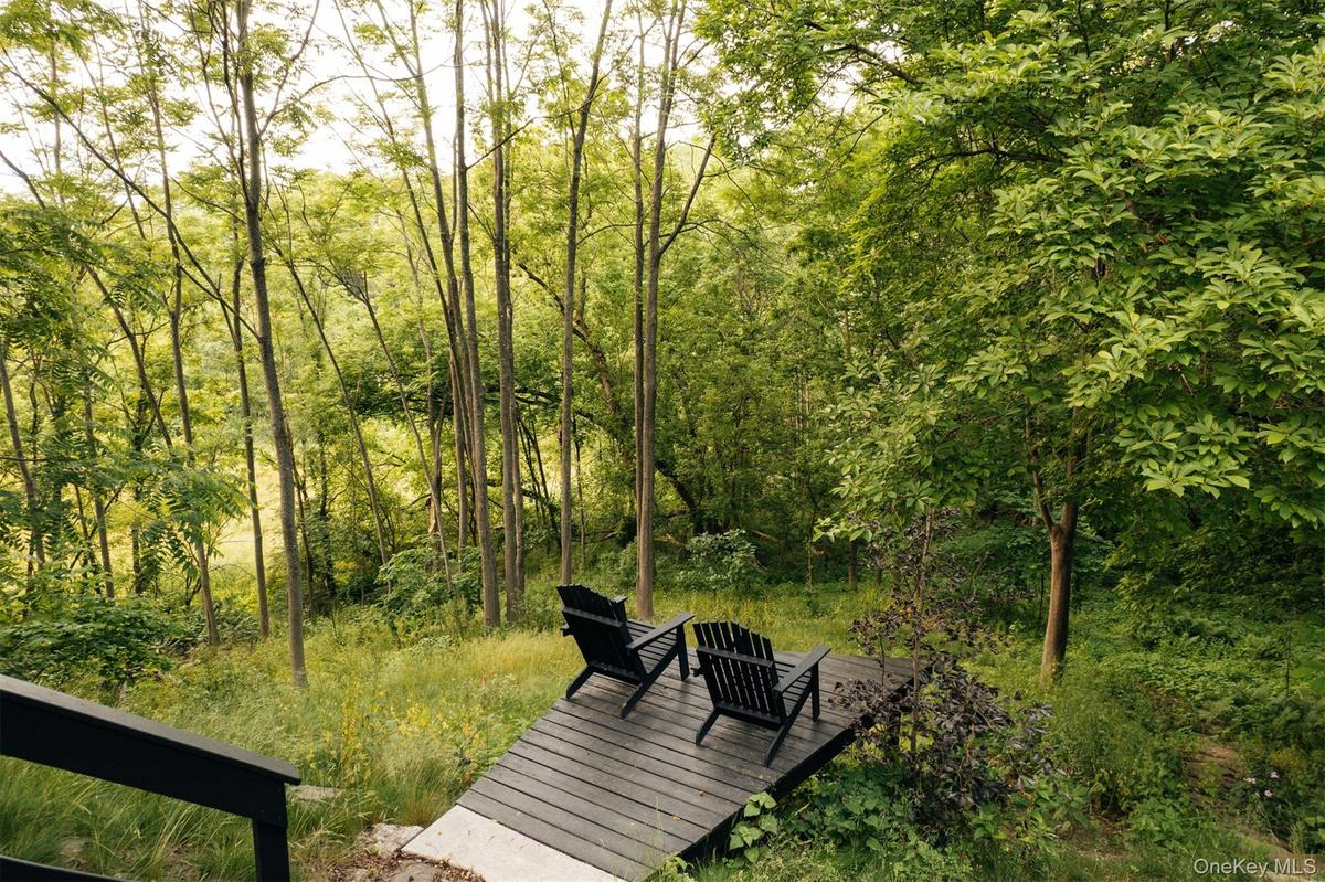 Surrounding community featuring a deck and a forest view