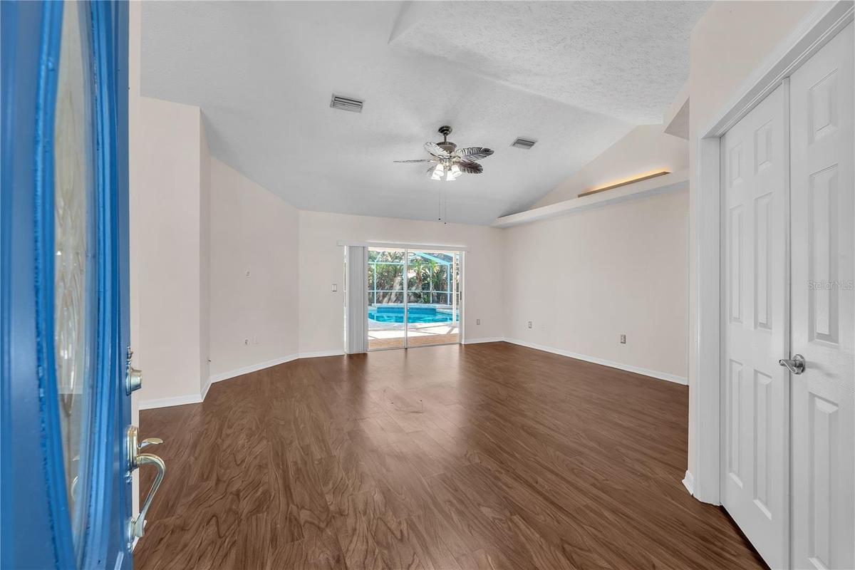 Step through the welcoming foyer and into the formal living and dining rooms with the double doors leading into a convenient office space or forth bed