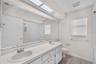 Full bathroom that is shared by the secondary bedrooms has dual sinks and a tub/shower combination.