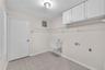 A spacious laundry room with a convenient utility sink adds functionality to everyday living.