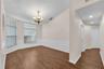 The dining room is conveniently located just off the kitchen and features charming shiplap wainscoting with a classic chair rail, adding texture and c