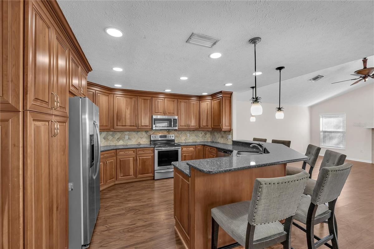 There is a double cabinet pantry to store all of your kitchen essentials next to the refrigerator.