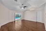 As you enter the living room, your eye is naturally drawn through the space to the sparkling pool and inviting backyard beyond, creating an immediate 