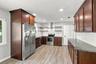 Granite counters, stainless steel appliances and a vented hood above the range give this kitchen a contemporary look and feel with excellent functiona