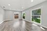 This room is across from the kitchen and enjoys views of the front yard and majestic oak tree.