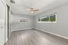 The primary bedroom has a walk-in closet and barn door to the ensuite bathroom.
