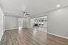 This large room off the kitchen also opens up to the Florida room and fireplace. The door on the far wall is to the primary bedroom and ensuite bathro