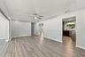 The hall on the far side leads to two additional bedrooms that share a bathroom. The split floor plan is great for creating separation and privacy for