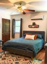 Upper Apartment  Bedroom with Hardwood-style flooring and his and her closets