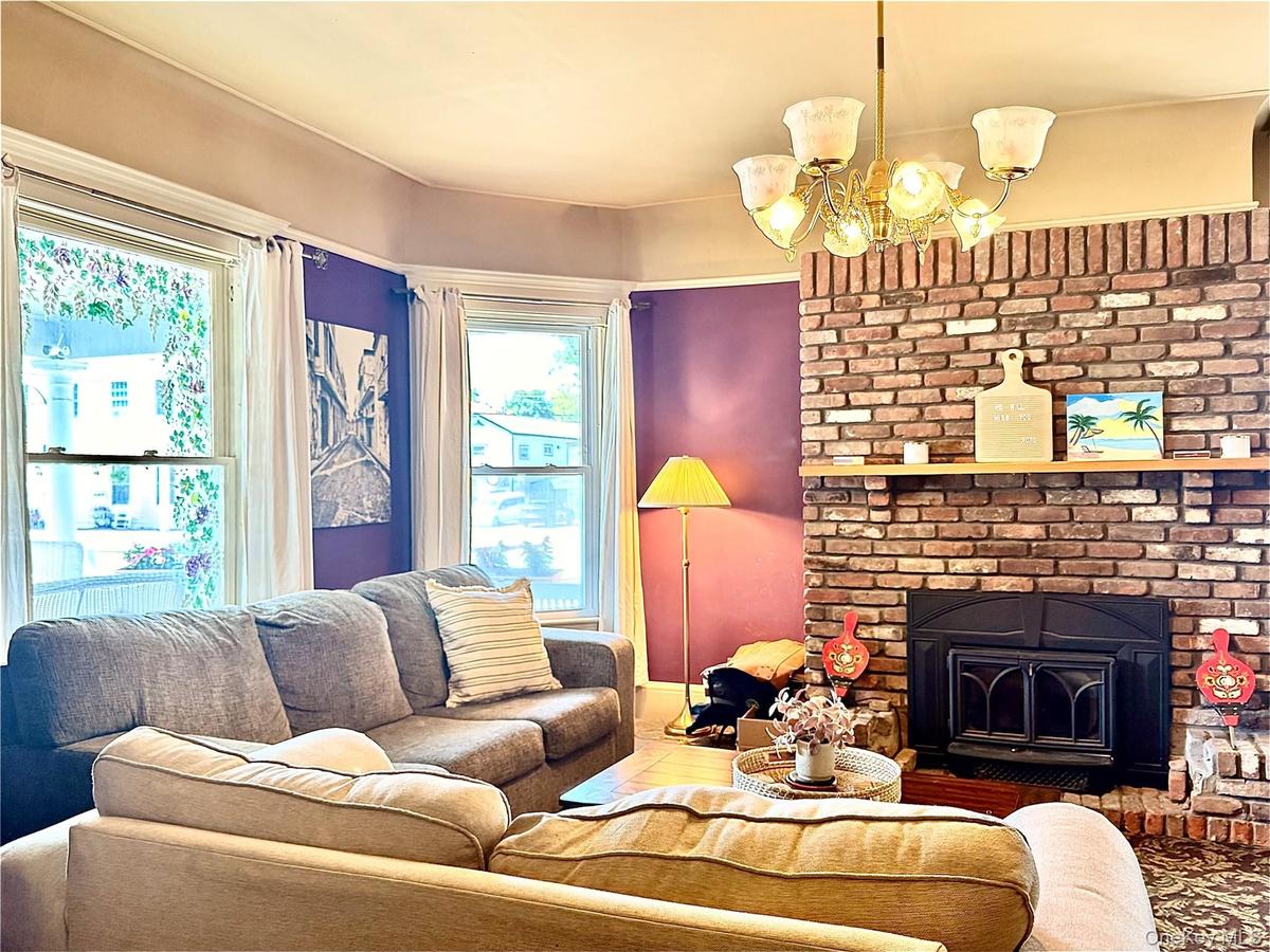 Main House Living Room Brick fireplace with large windows