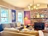 Main House Living Room Brick fireplace with large windows