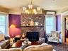 Main House Living Room Brick fireplace with two large windows