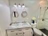 Cottage In The Back Bathroom Dual vanity with stone countertop, undermount sinks, and brushed nickel fixtures