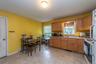 Kitchen featuring wood-finish cabinetry, a stainless steel sink, and a four-burner gas range