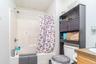 Shower/tub combination with chrome fixtures and integrated shelving