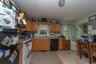 Kitchen featuring wood cabinetry, a white gas range, and a black dishwasher
