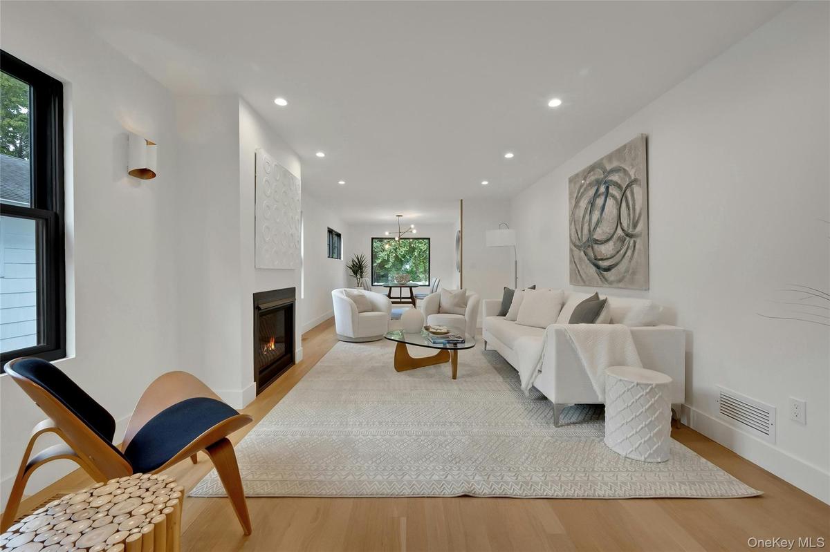 A bright and inviting living room anchored by a cozy gas fireplace.
