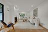 A bright and inviting living room anchored by a cozy gas fireplace.