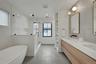 Spa-like primary bath is as beautiful as it is functional, with radiant heated floors, soacking tub, oversized shower, double vanity, and plenty of th