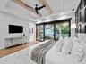 Guest bedroom with accent wall and sliding doors