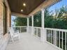 Covered front porch with white railing